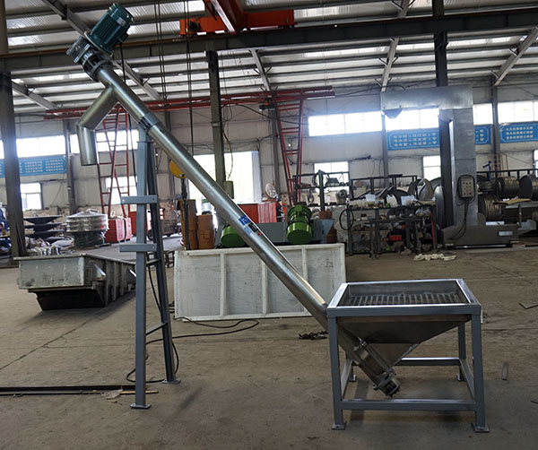 What material does the inclined screw conveyor convey?